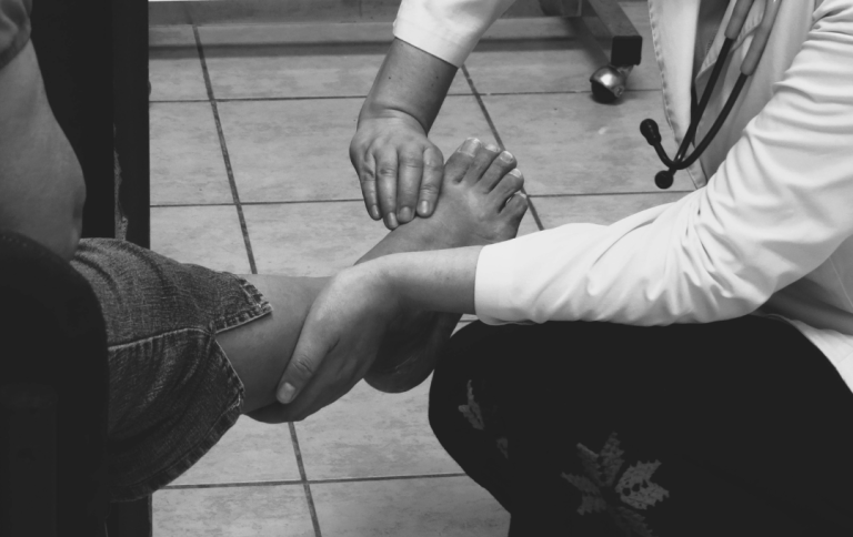 Vascular specialist checking patient's leg for signs of PAD