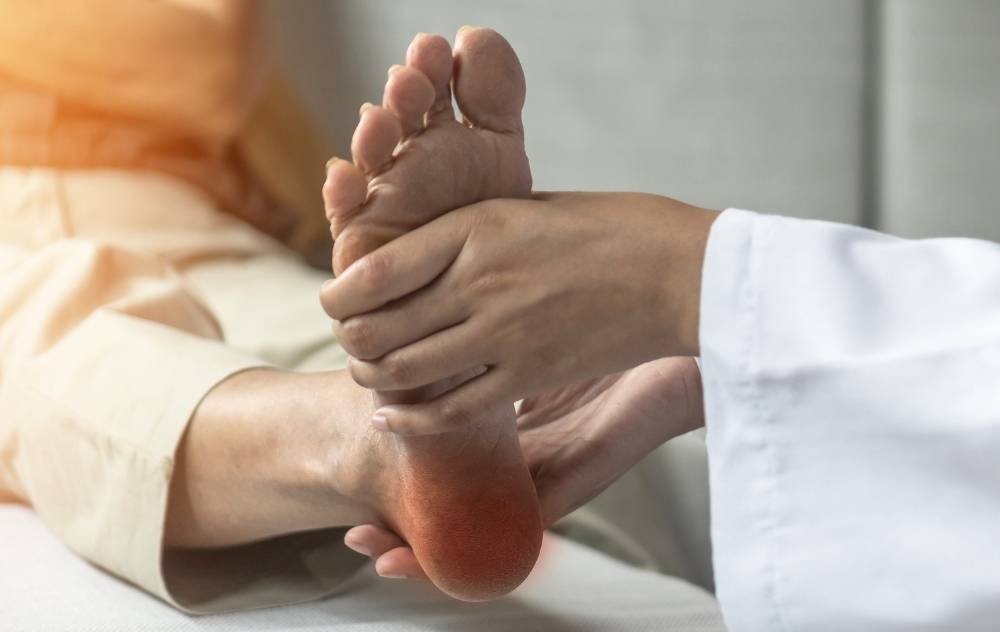Doctor examining womans foot