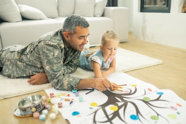 Father and daughter filling out family tree map