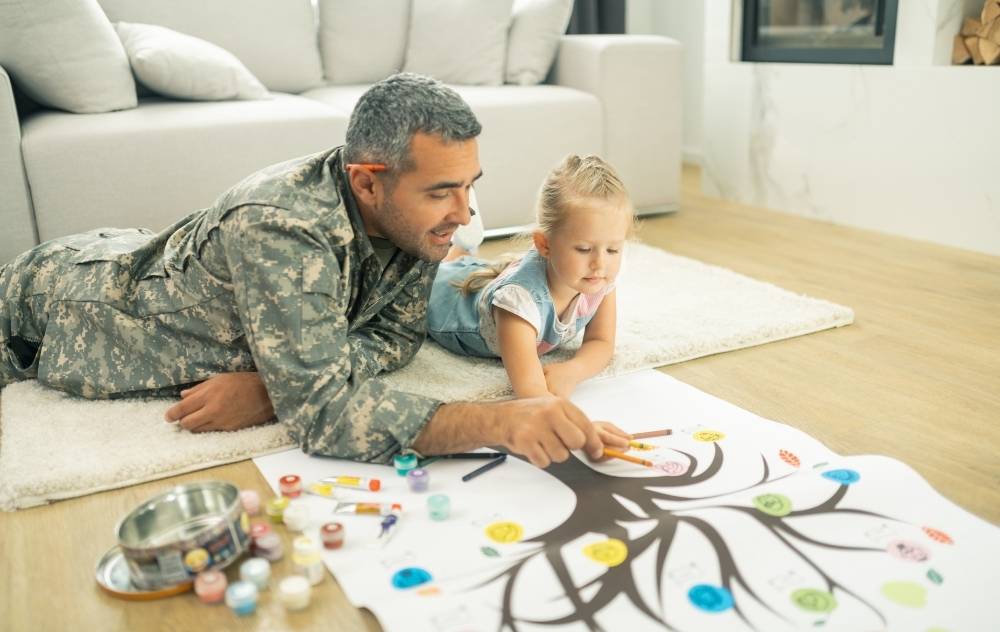 Father and daughter filling out family tree map