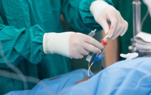 Doctor using arterial catheter