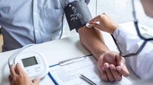 Man getting blood pressure tested by doctor