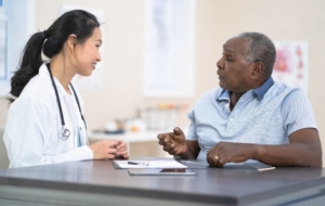 Doctor speaking with senior man