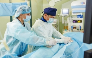 Two vascular doctors performing a medical treatment