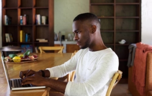 Young man researching on computer about vascular disease