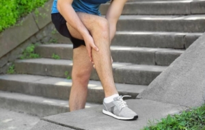 Man experiencing leg pain outside