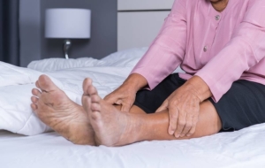 Woman laying in bed with diabetic leg pain