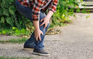 Man experiencing pain in his lower leg outside