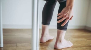 Woman clutching her calf in pain