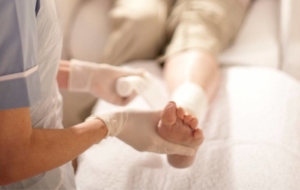 Woman getting her leg wrapped by nurse