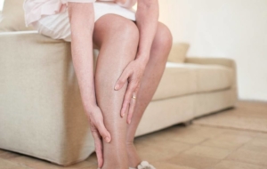 Woman experiencing painful arterial disease symptoms in leg