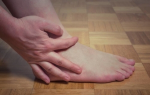 Holding painful leg and foot with PAD