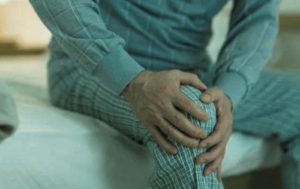 Man experiencing leg pain at night