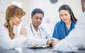 Group of physicians reviewing patient profile.